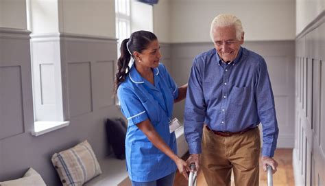 Badante che prepara un pasto per un anziano