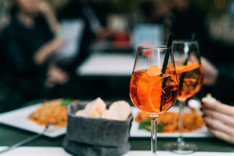 Immagine di un tavolo da aperitivo con Spritz e stuzzichini salati